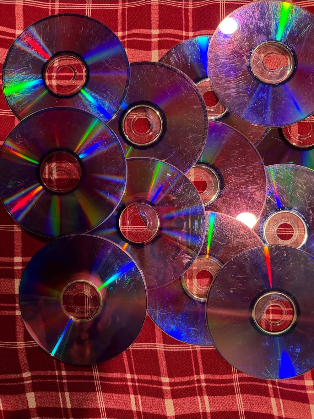 Lot of 12 iridescent CDs/DVDs non working scratched great for projects/art/craft